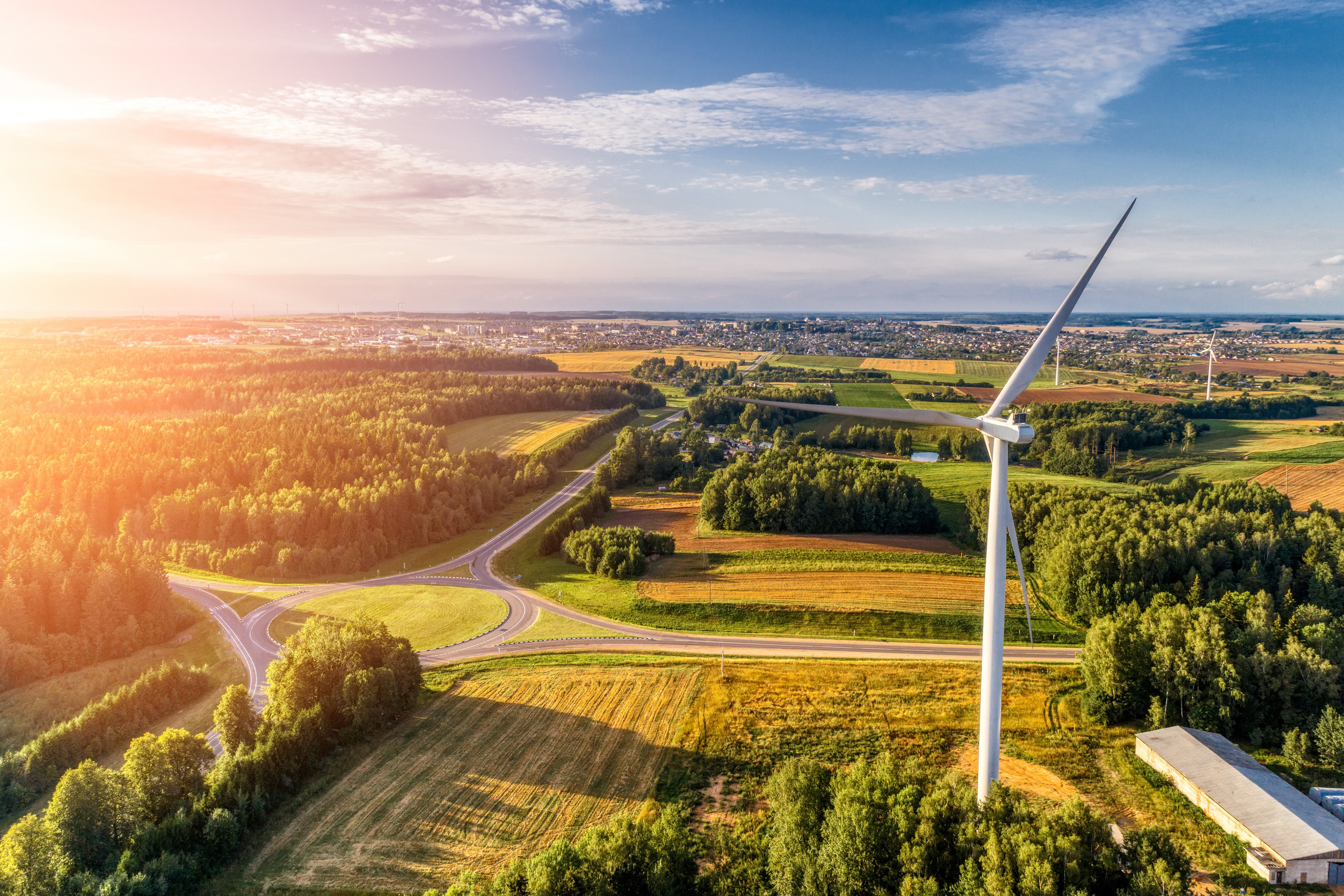 wind turbine with green fields promoting sustainable manufacturing processes 