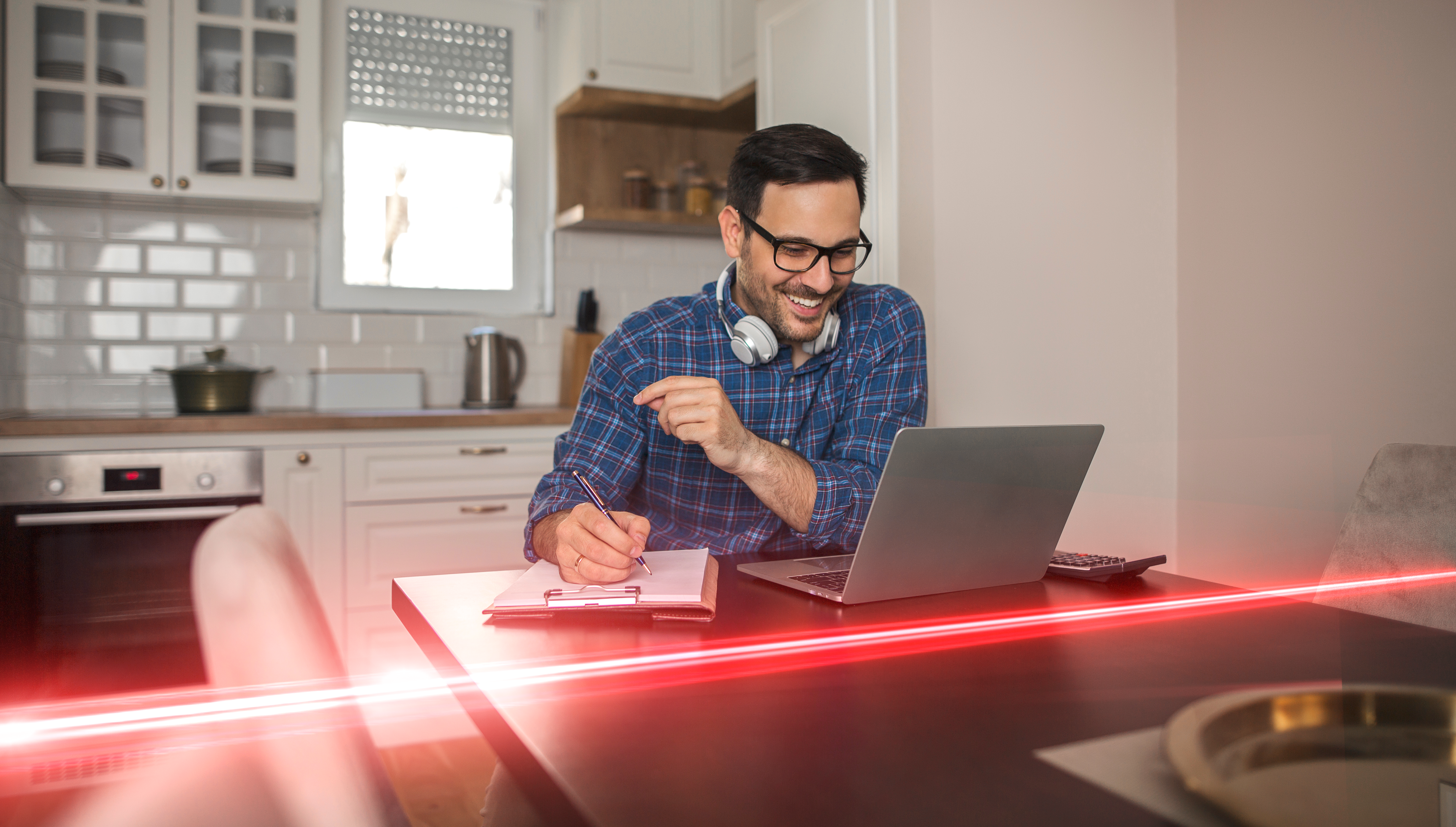 man sat at laptop with red eplan strobe